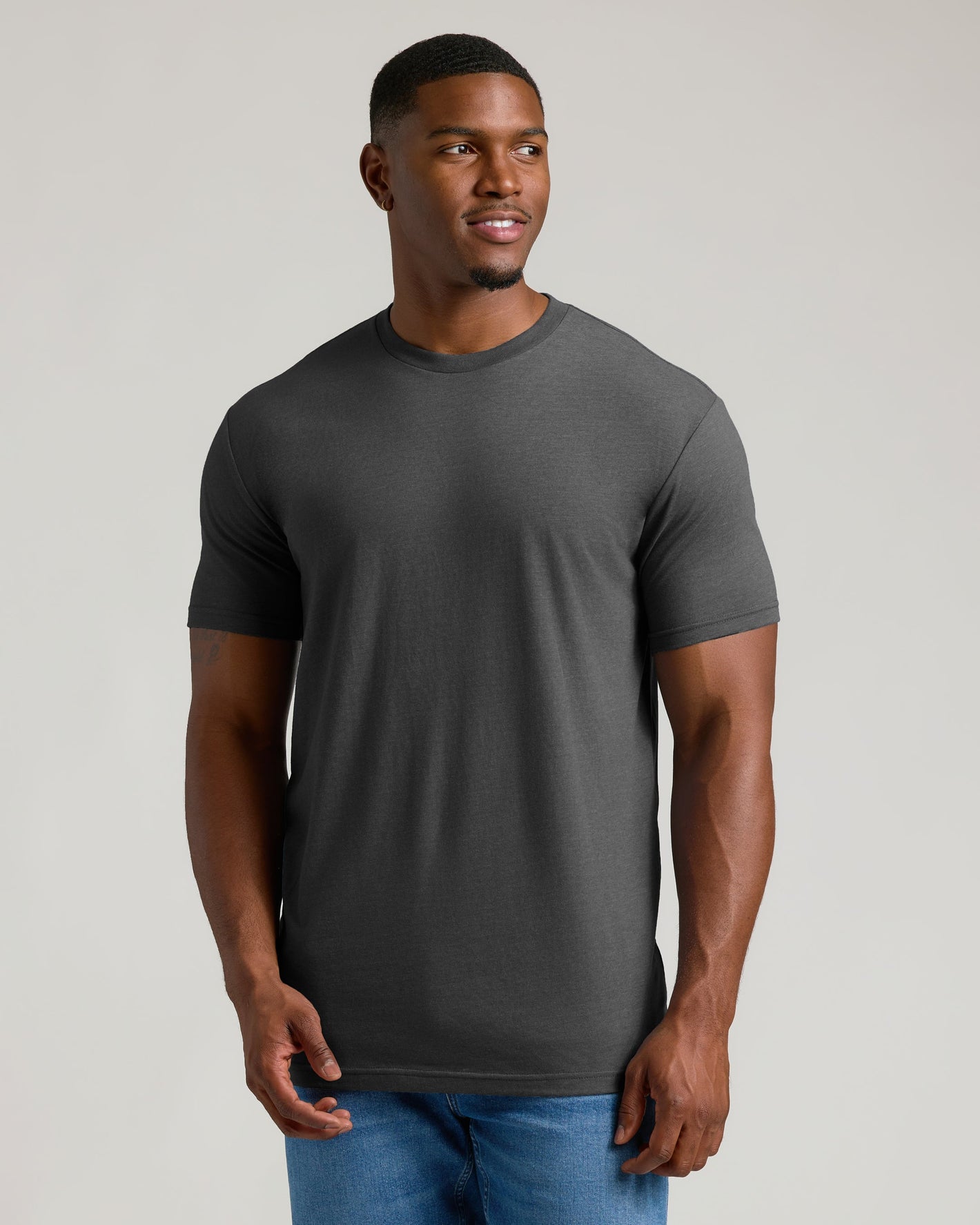 Man in Charcoal Heather Gray Tall Crew Neck T-Shirt and blue jeans.