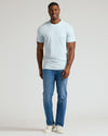 Man wearing Icicle Tall Straight Hem Crew Neck T-Shirt, jeans, sneakers.