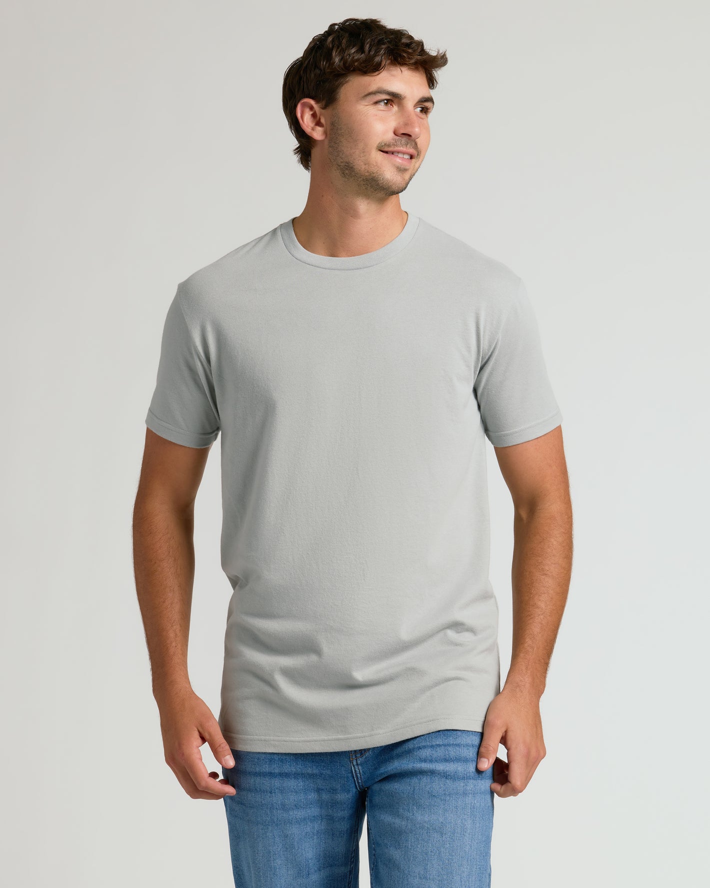 Young man in Steel Tall Straight Hem Crew Neck T-Shirt, smiling.