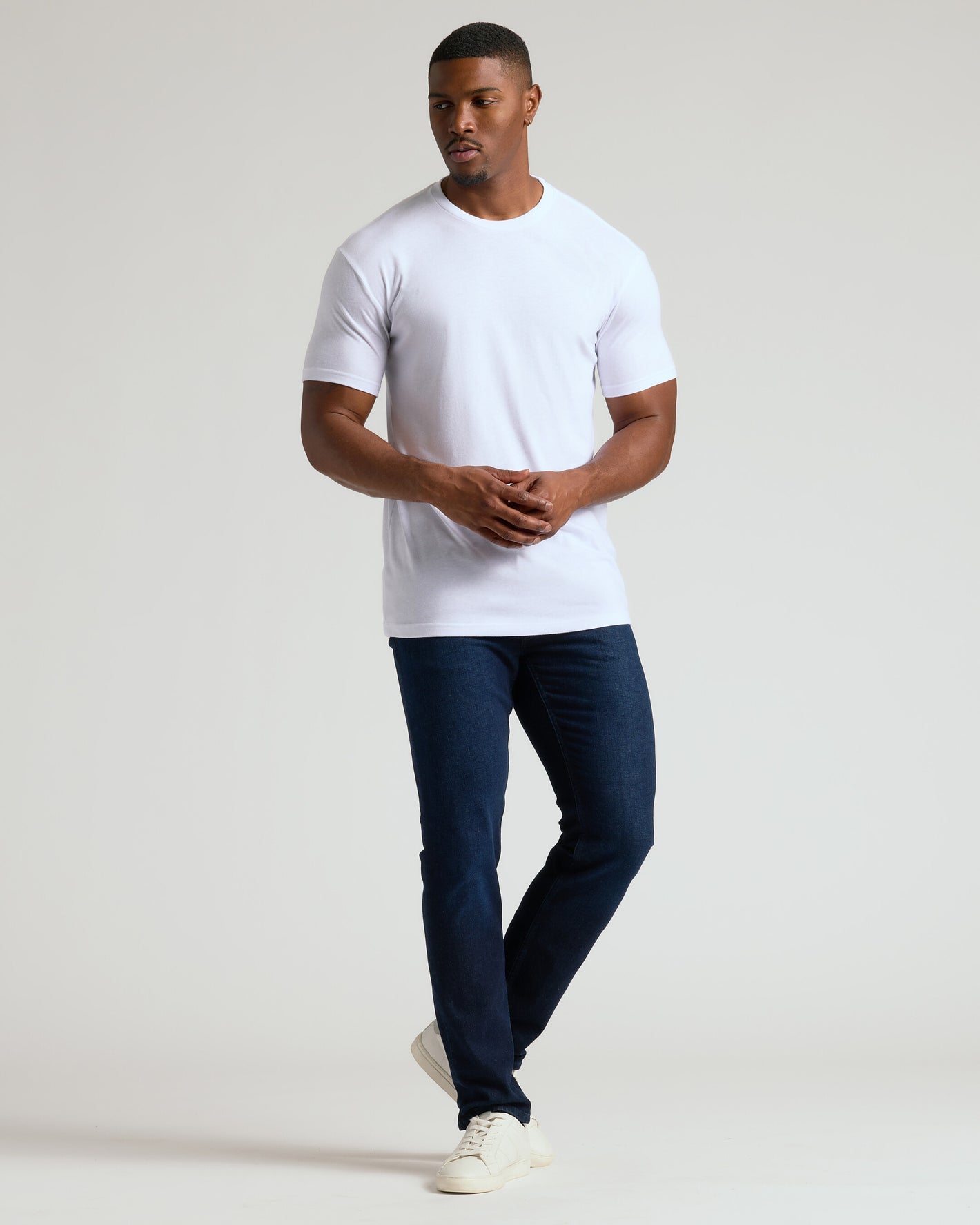 Man wearing Black & White Tall Classic Crew T-shirt with jeans and sneakers.