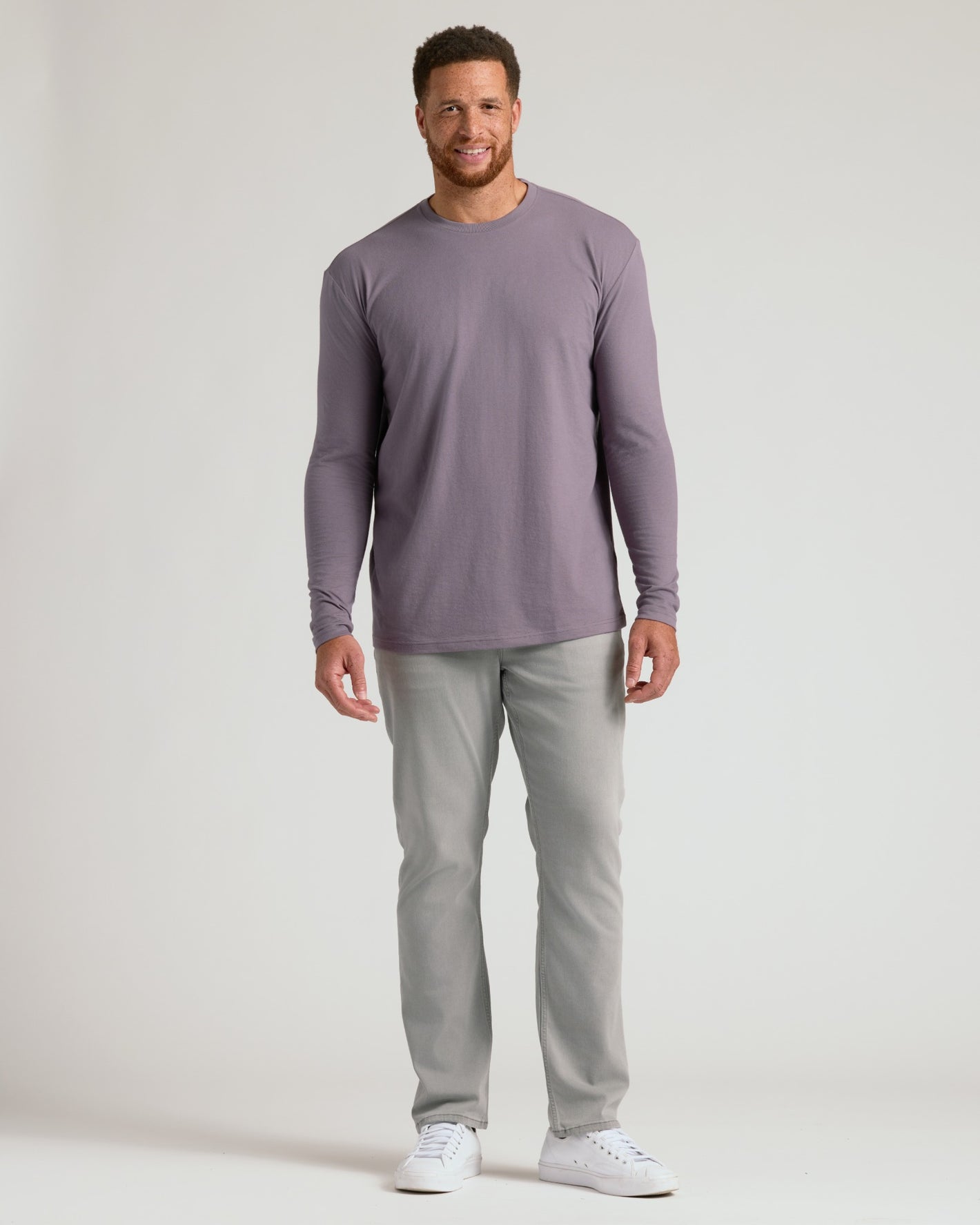 Man wearing Ashberry Tall Long Sleeve T Shirt with grey pants.