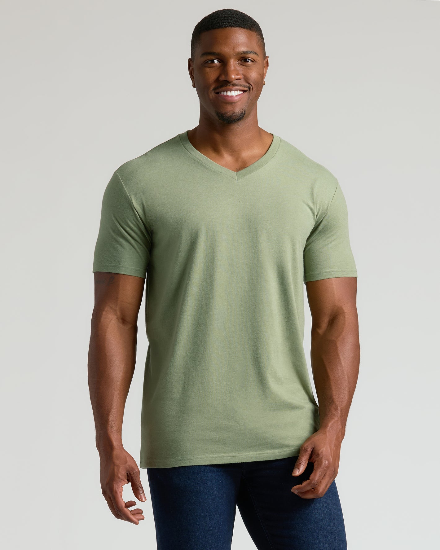 Man wearing Dark Heather Bay Green Tall Classic V-Neck, smiling, relaxed stance.
