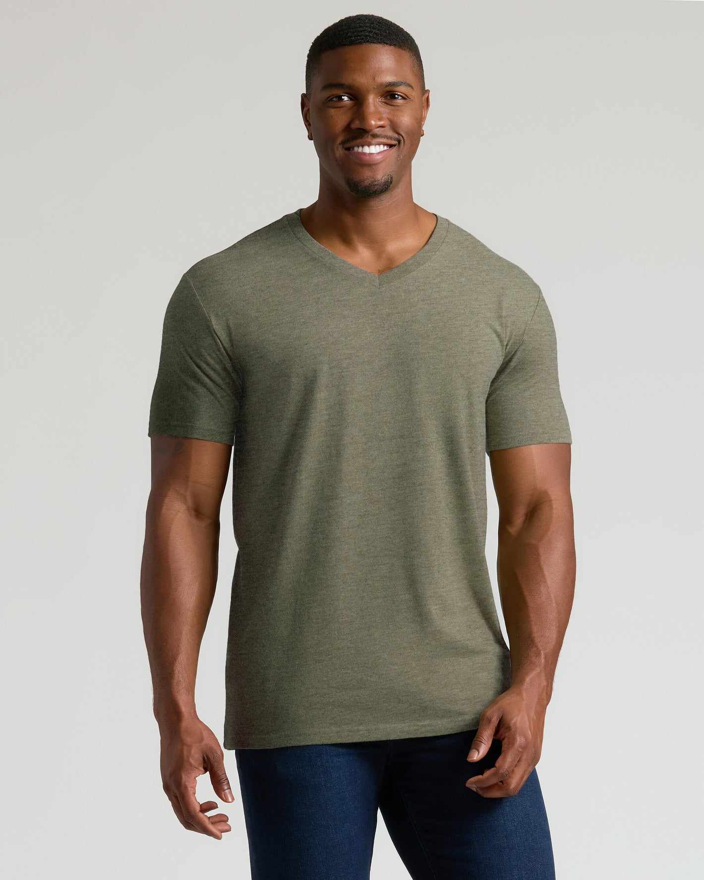 Model wearing Heather Military Green Tall Short Sleeve Classic V-Neck with dark jeans.