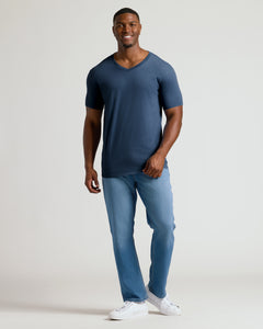 True ClassicHeather Navy Tall Short Sleeve Classic V-Neck worn by smiling man in jeans.