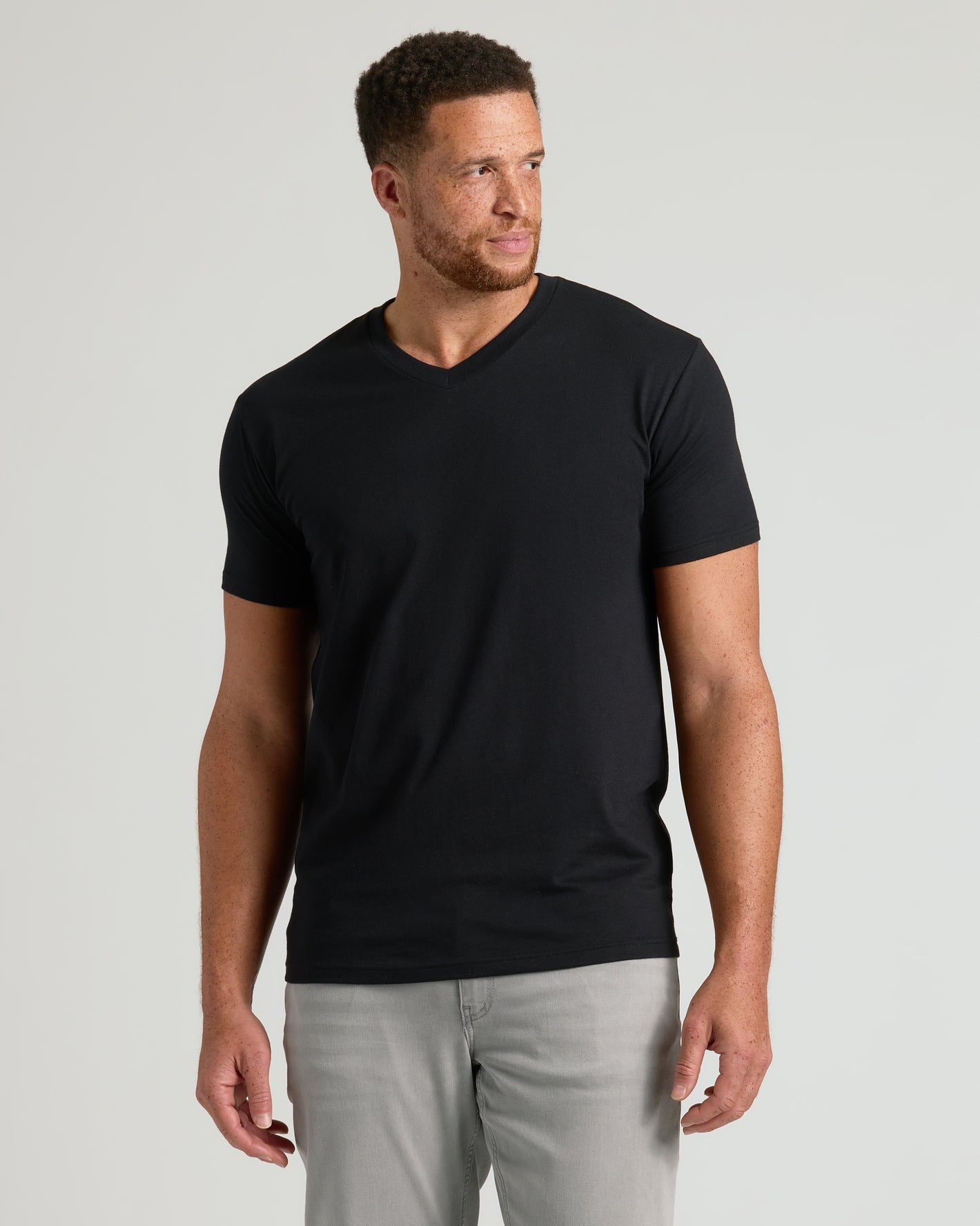 Black Classic Tall V-Neck 10-Pack on model in gray pants.