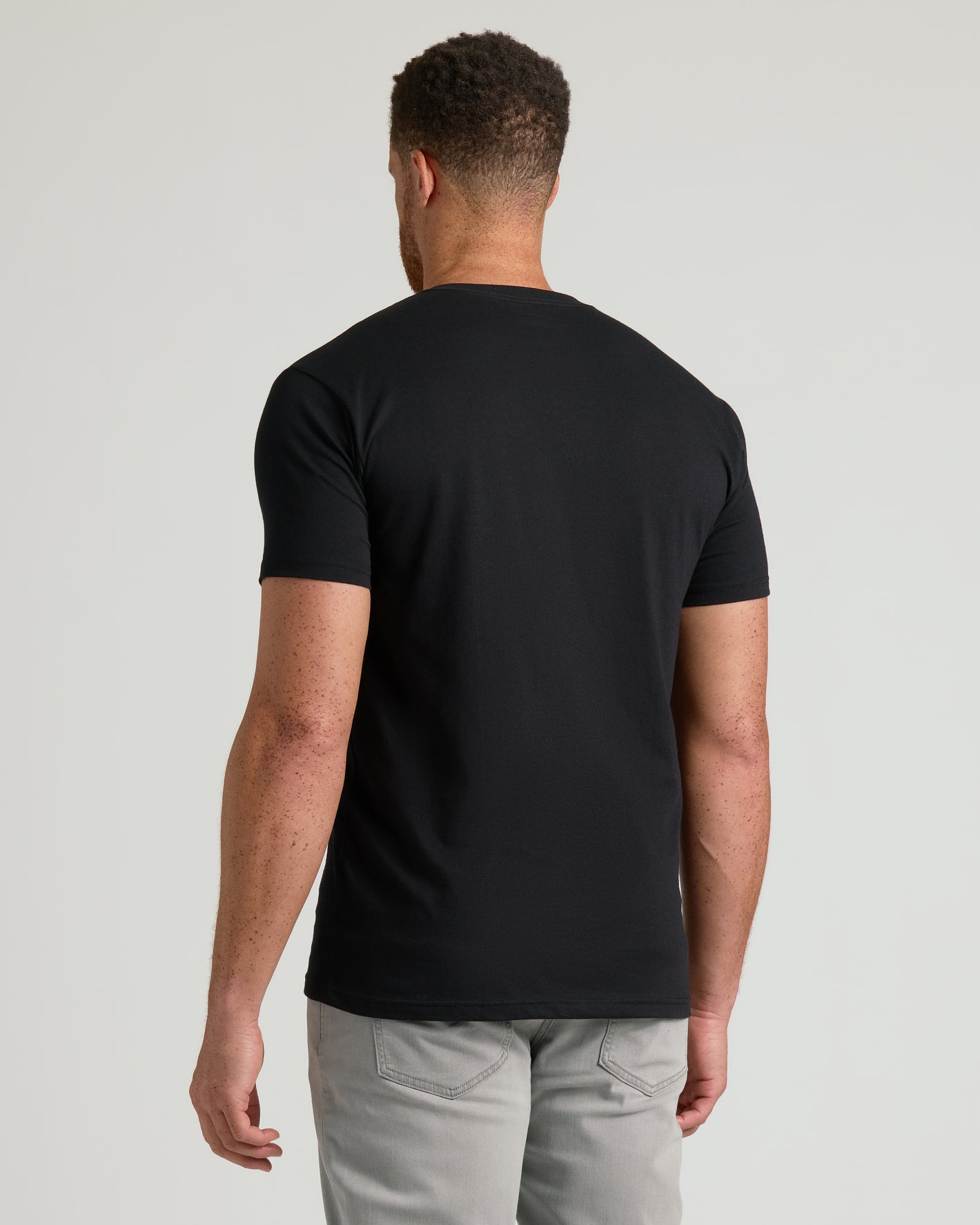 Black Classic Tall V-Neck 10-Pack: back view of model wearing black tee.
