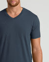 Man wearing a dark blue t-shirt against a plain background