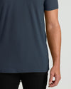 Person wearing a dark blue t-shirt on a plain background