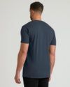 Man wearing a dark blue t-shirt on a light gray background