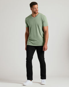 True ClassicMan wearing a green t-shirt and black pants on a white background