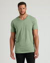 Man wearing a green t-shirt against a plain background