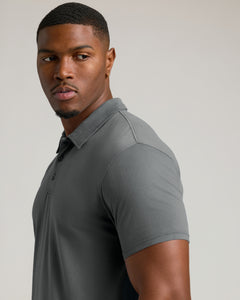 True ClassicYoung man wearing fitted Carbon Short Sleeve Tall Polo, highlighting collar and shoulders.