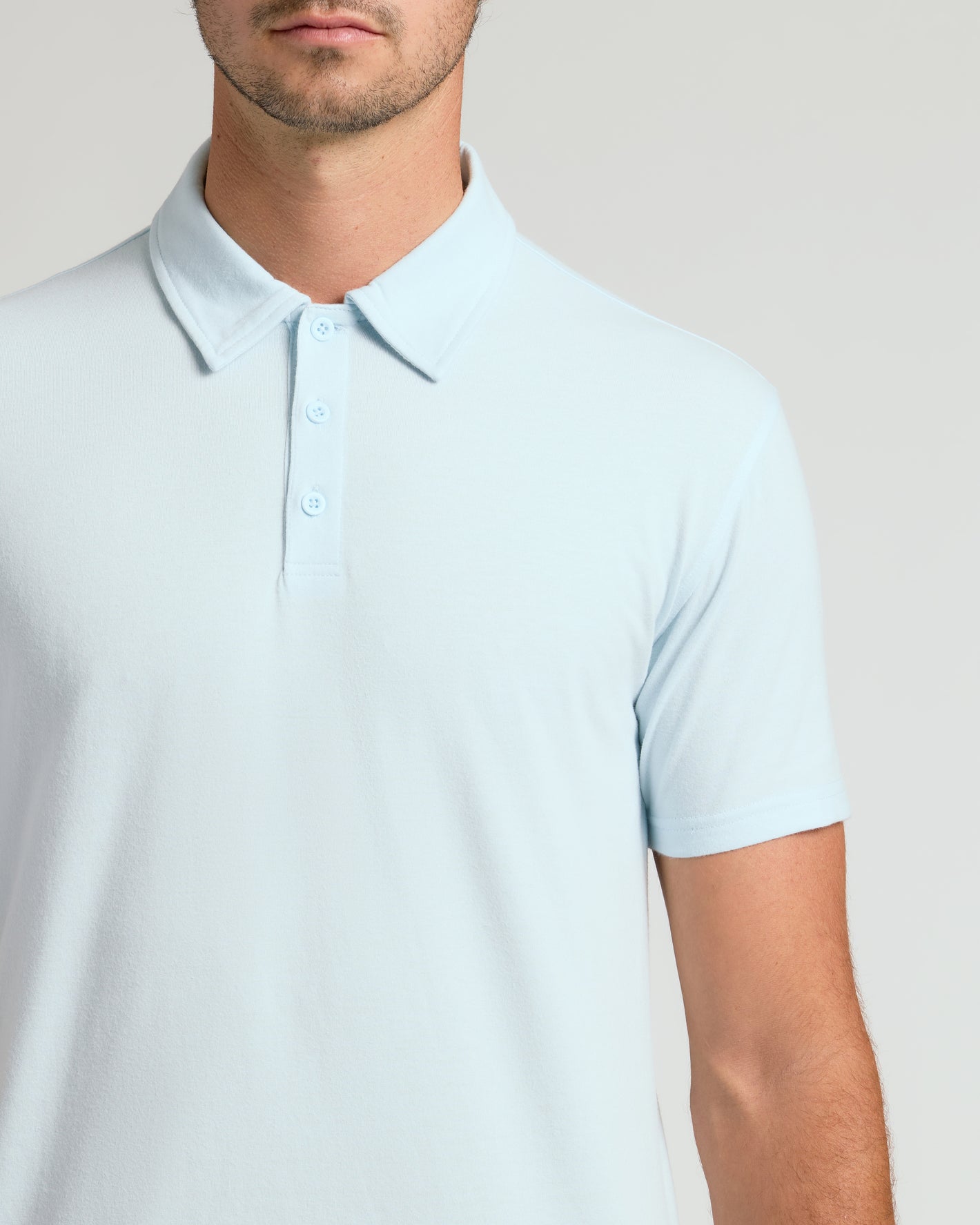 Man wearing Icicle Short Sleeve Tall Polo, showcasing fit and collar details.