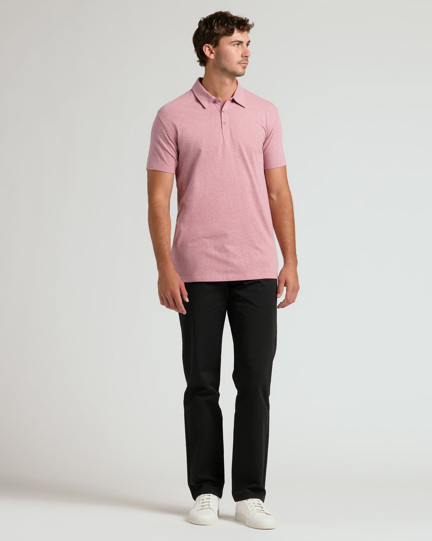 Light Heather Boysenberry Short Sleeve Tall Polo on model with black pants.