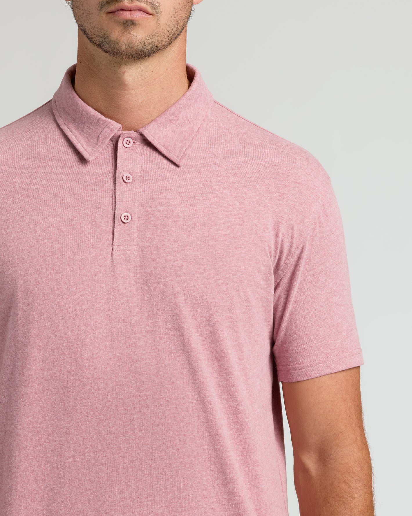 Man wearing Light Heather Boysenberry Short Sleeve Tall Polo with classic collar.