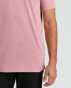 Midsection wearing Light Heather Boysenberry Short Sleeve Tall Polo and black pants.