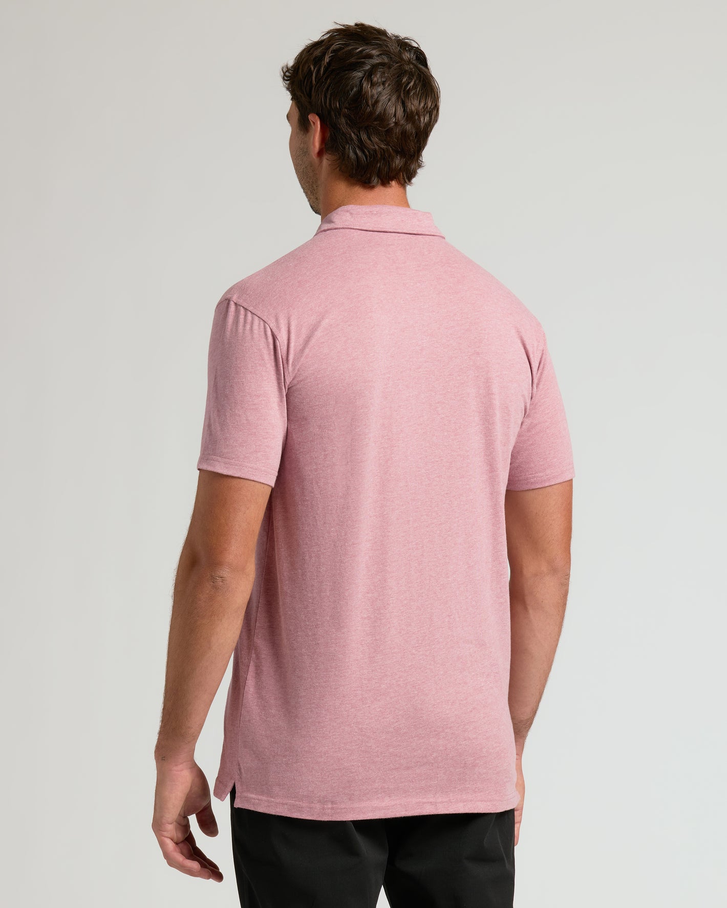 Back view of Light Heather Boysenberry Short Sleeve Tall Polo on male model.