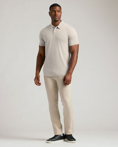 True ClassicSeasonal Tall Classic Polo 3-Pack modeled by a man in beige.