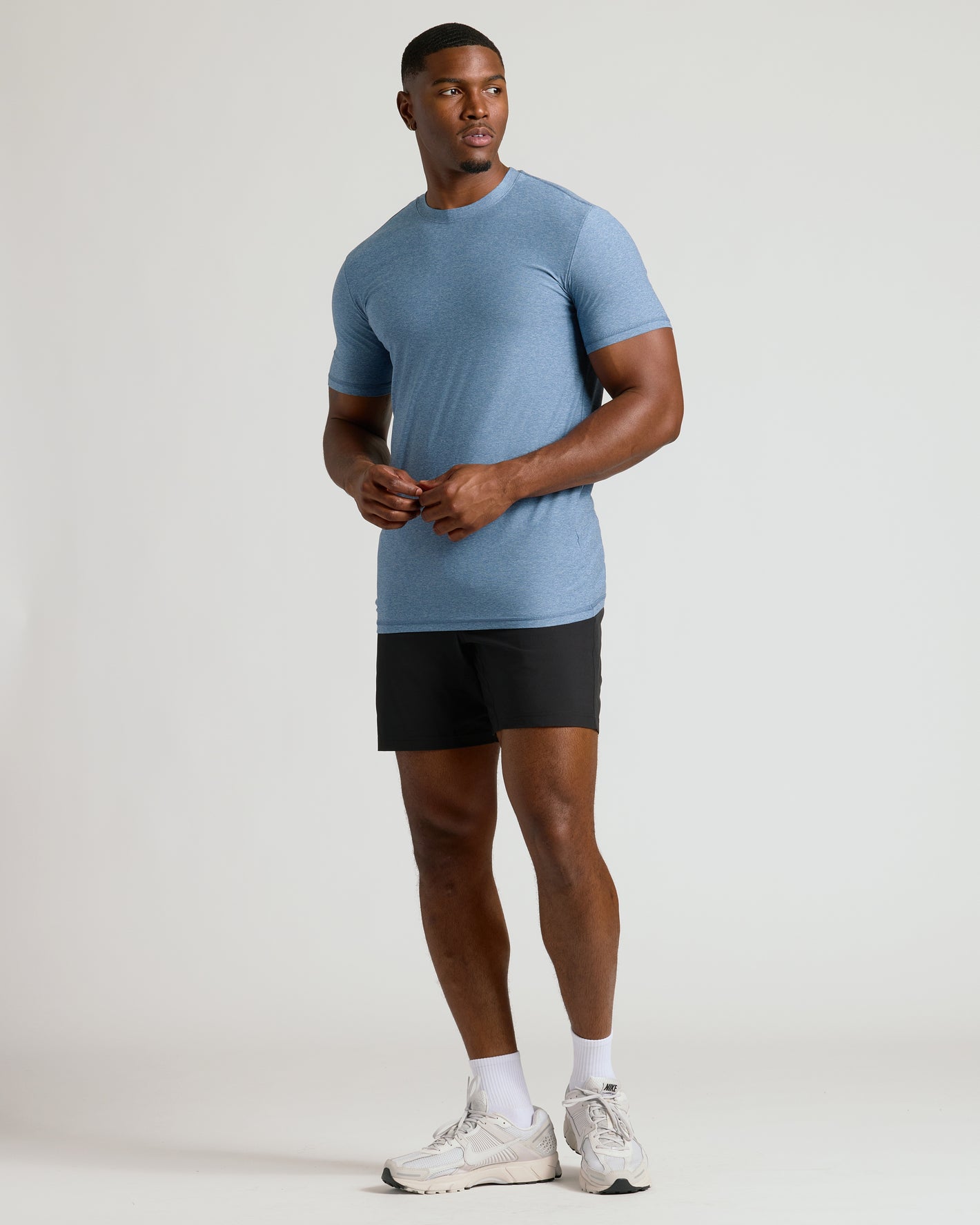 Heather Azul Tall Active Crew Neck 2.0 modeled with athletic shorts and sneakers.