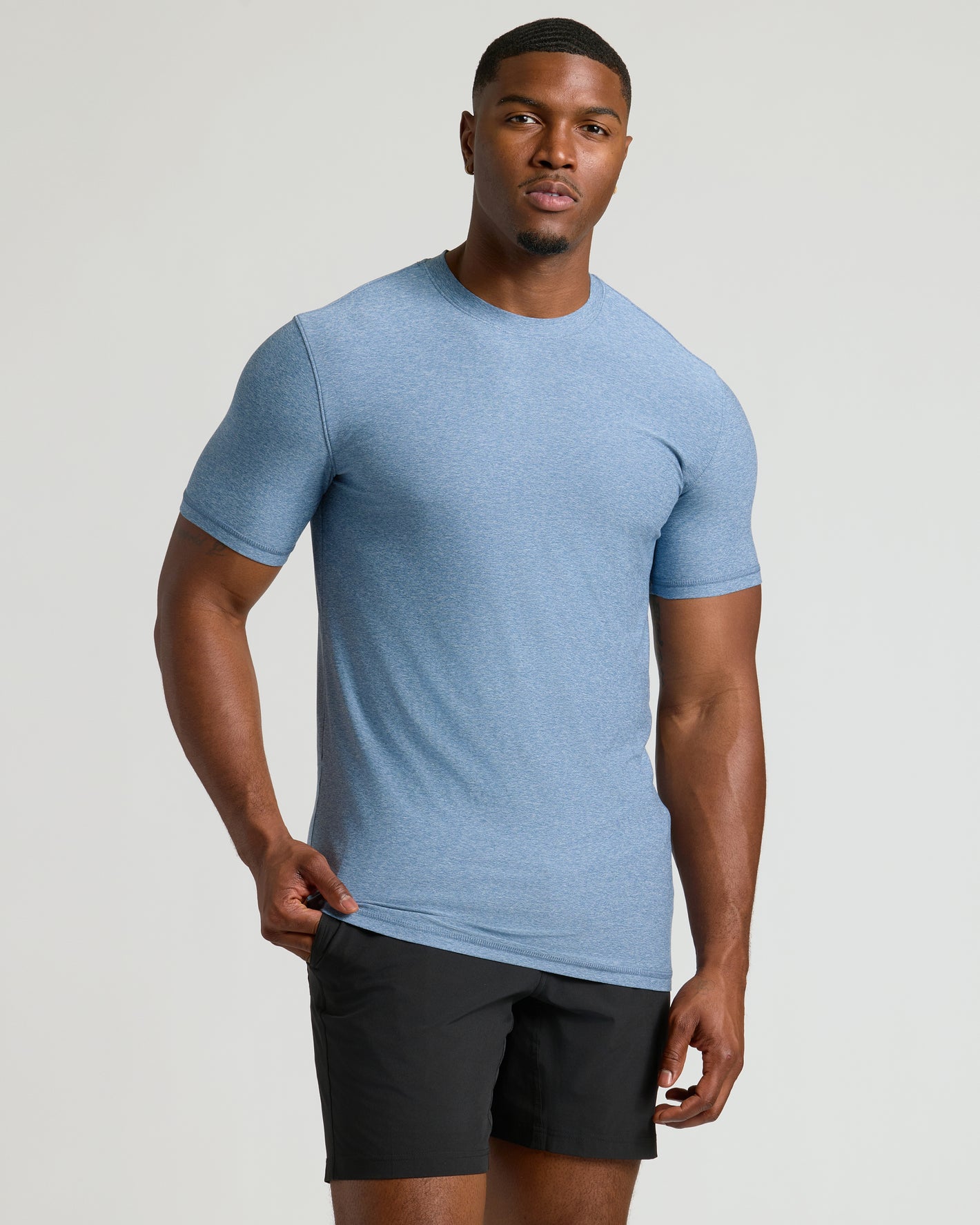 Model wearing Seasonal Tall Active Crew 3-Pack T-shirt and black shorts.