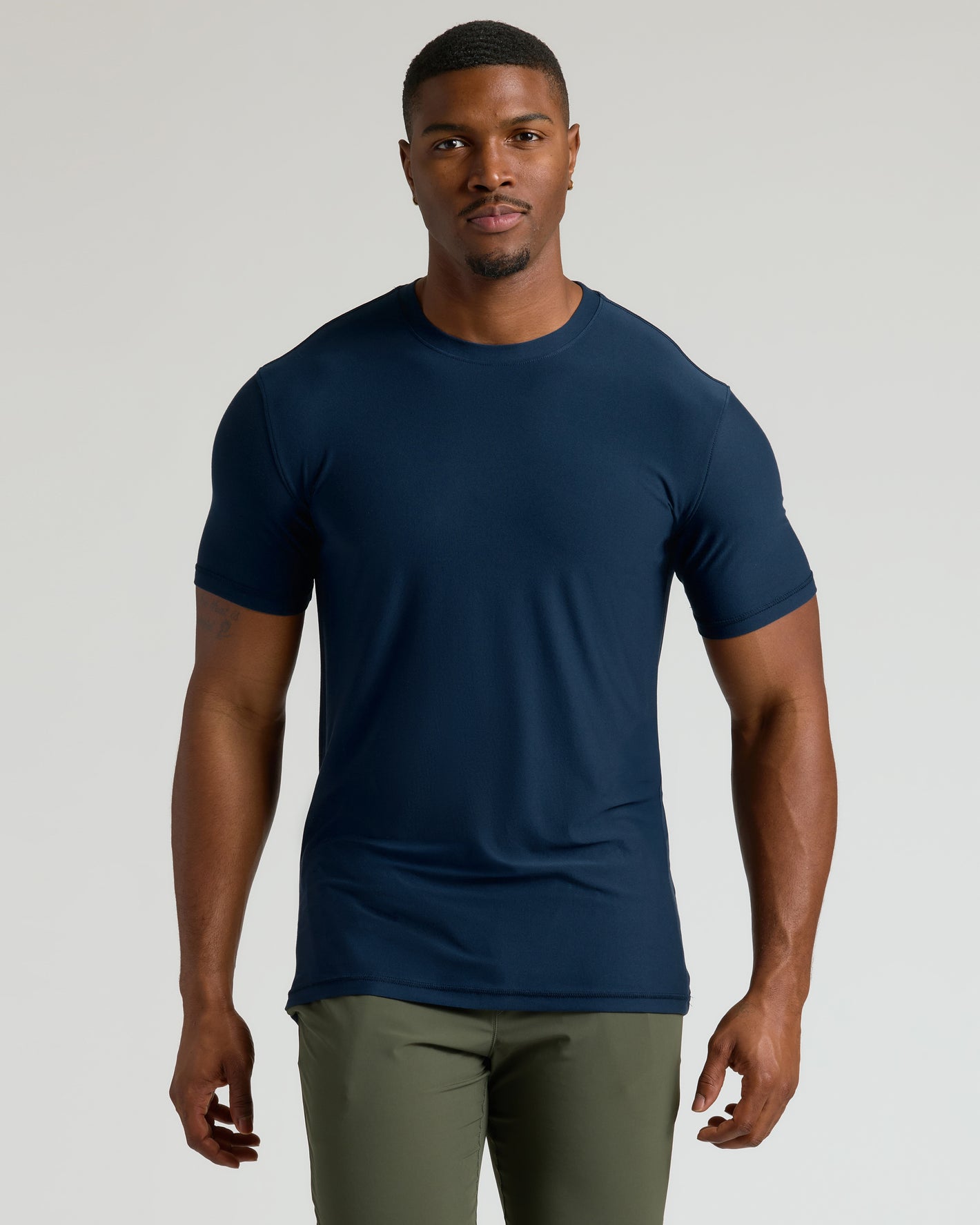 Model wearing Timeless Tall Active Crew in navy blue, showcasing stretchy, moisture-wicking fabric.