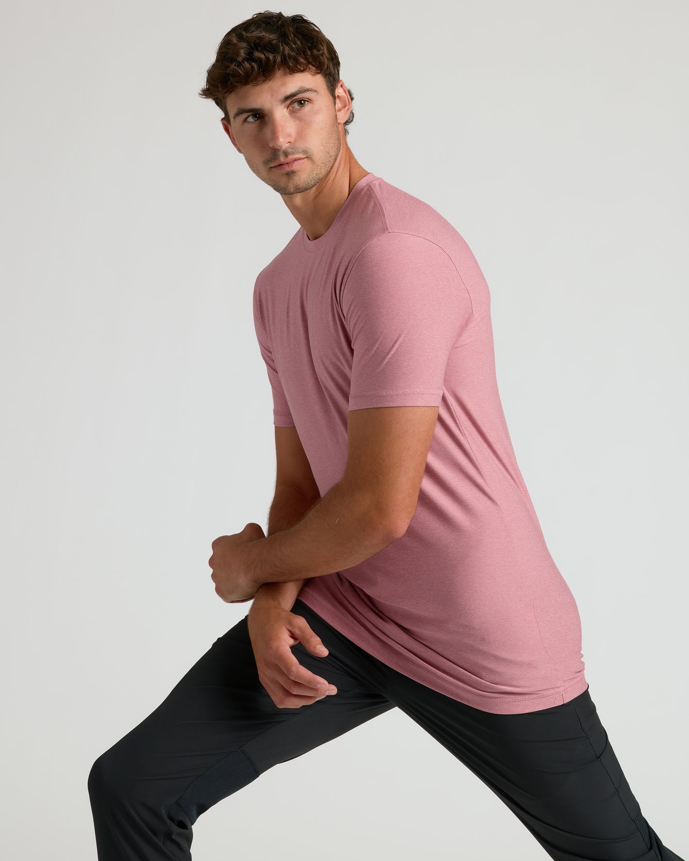 Quartz Rose Tall Active Crew Neck 2.0 on young man, stretching pose.