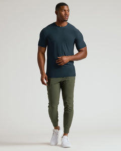 True ClassicMan wearing a dark green t-shirt and olive green pants on a white background