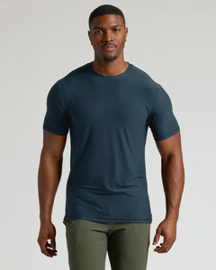 True ClassicMan wearing a dark blue t-shirt and green pants on a light gray background