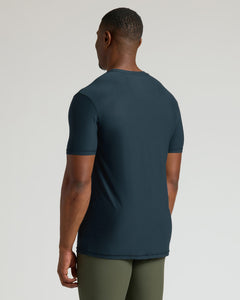 True ClassicMan wearing a dark blue t-shirt and green pants on a light gray background