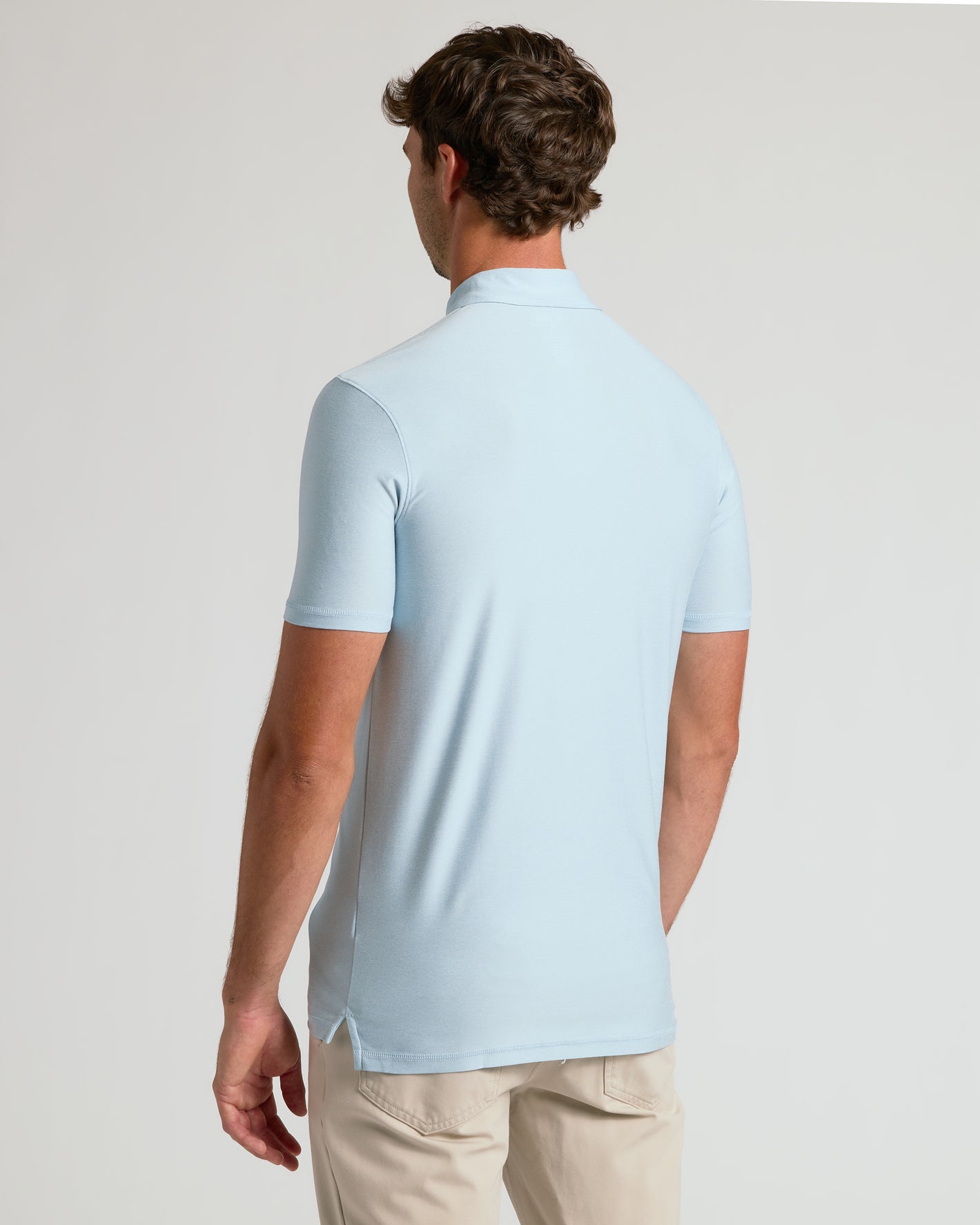 Back view of Arctic Short Sleeve Tall Active Polo on a man.