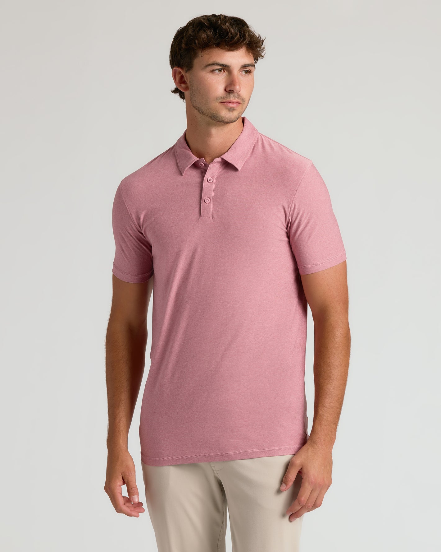 Model in Quartz Rose Short Sleeve Tall Active Polo, beige trousers.