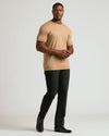 Man wearing Tahini Tall Premium Pima Crew Neck with slim black pants.