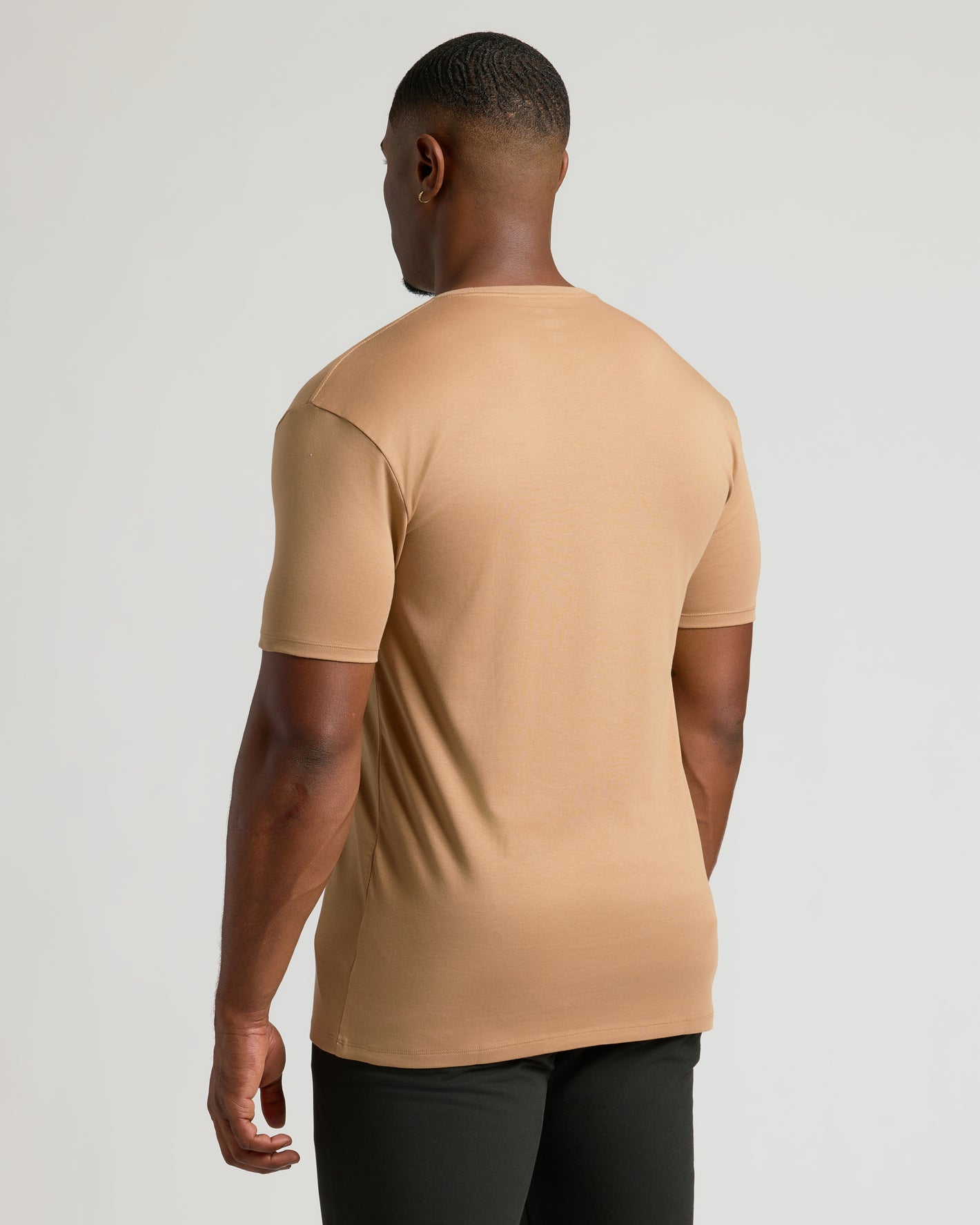 Man wearing Tahini Tall Premium Pima Crew Neck, back view.