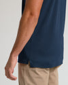 Navy Tall Pima Polo on person, showing side slit hem detail.