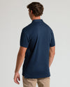 Back view of man in Navy Tall Pima Polo and khaki trousers.