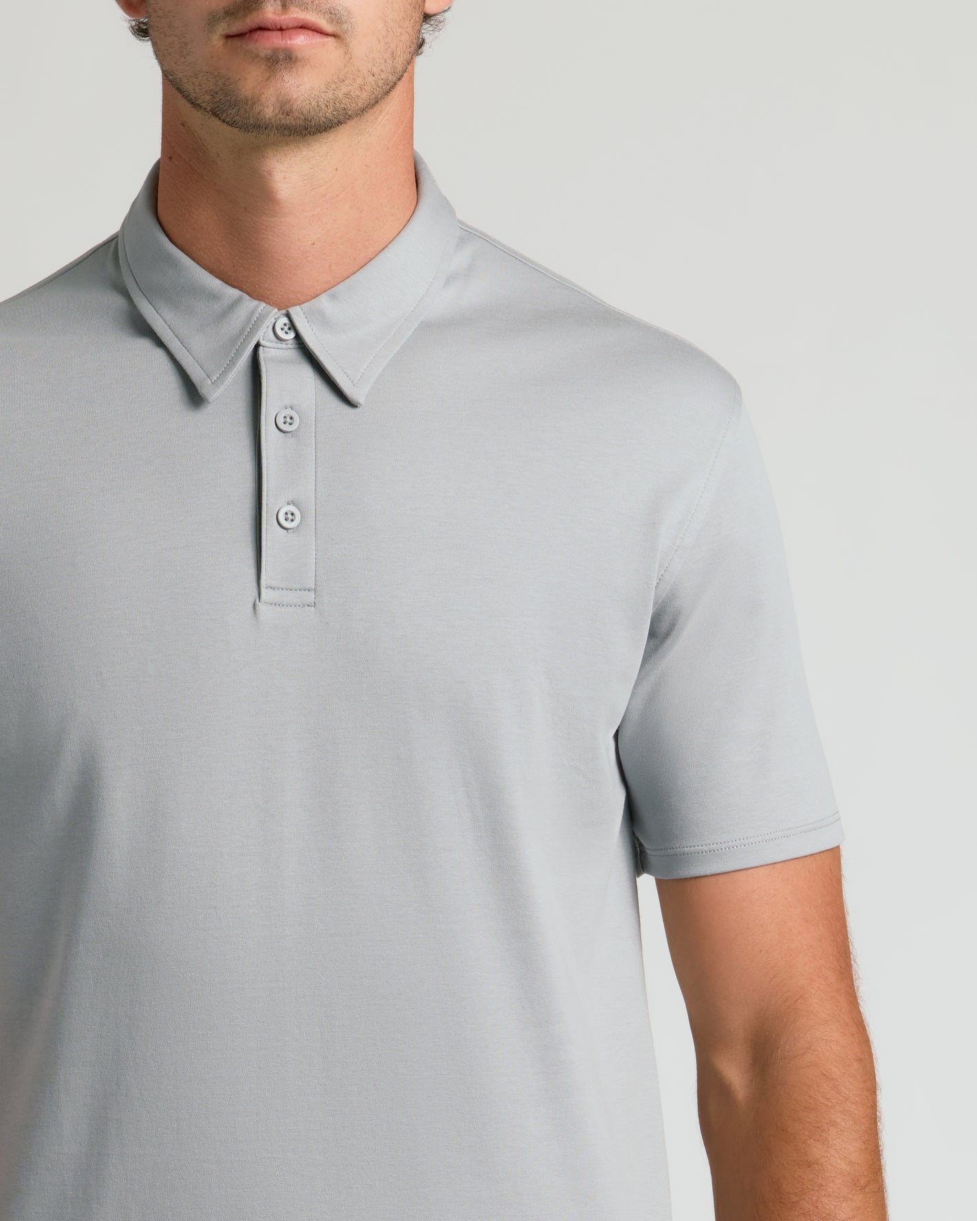 Man wearing Steel Tall Premium Pima Polo with pointed collar and buttons.