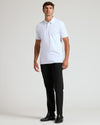 Man wearing White Tall Premium Pima Polo with black trousers and boots.