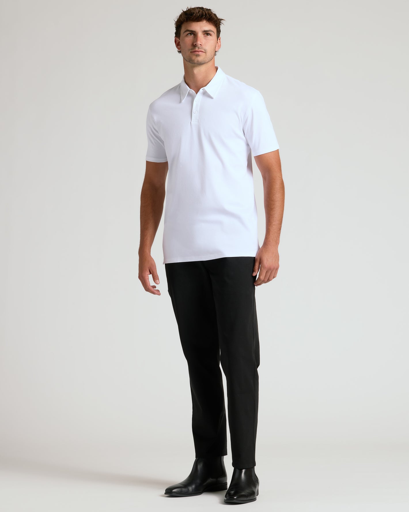 Man wearing White Tall Premium Pima Polo with black trousers and boots.