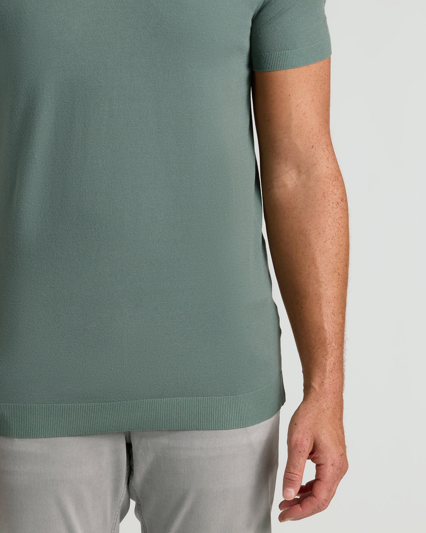 Moss Tall Dressy Polo showcased on model's midsection.