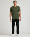 Man wearing Grove Tall Premium Pima V-Neck, black pants, white sneakers.