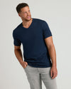 Man wearing Navy Tall Premium Pima V-Neck and gray pants.