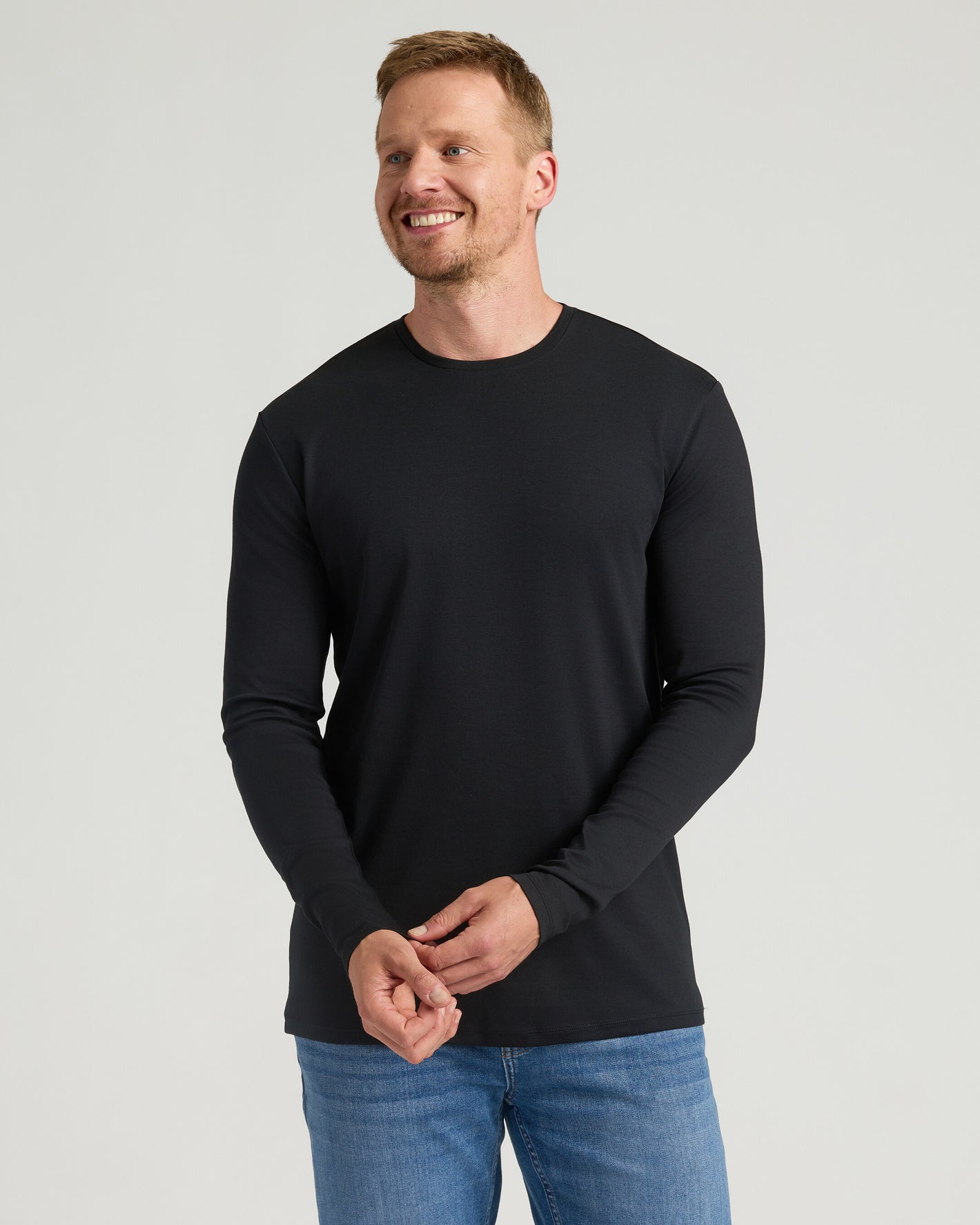 Man wearing All Black Tall Premium Pima Long Sleeve Crew.