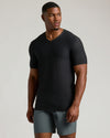 Model in Black Tall Active V-Neck against light-grey background.