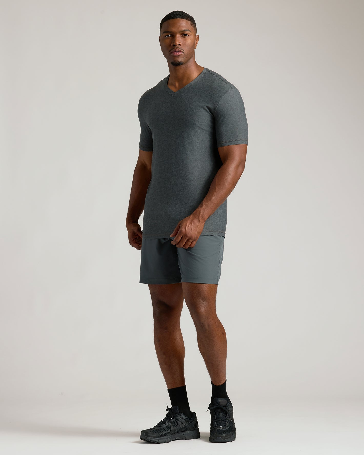 Man wears Charcoal Heather Gray Tall Active V-Neck and matching athletic shorts.