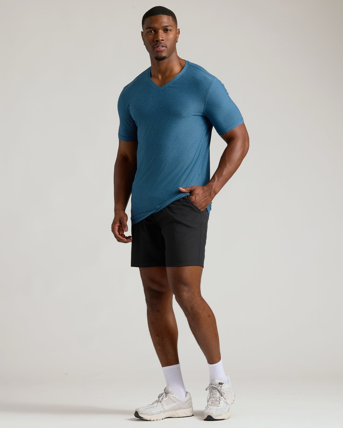 Male model in Dark Heather Bluebird Tall Active V-Neck.