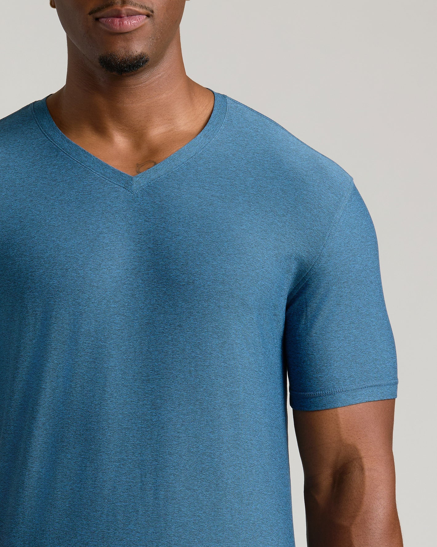 Man wearing Dark Heather Bluebird Tall Active V-Neck T-shirt.