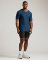 Man wearing Navy Tall Active V-Neck, black shorts, white socks, Nike shoes.