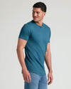 Man in Lagoon Tall Premium Pima Crew Curved Hem and jeans.
