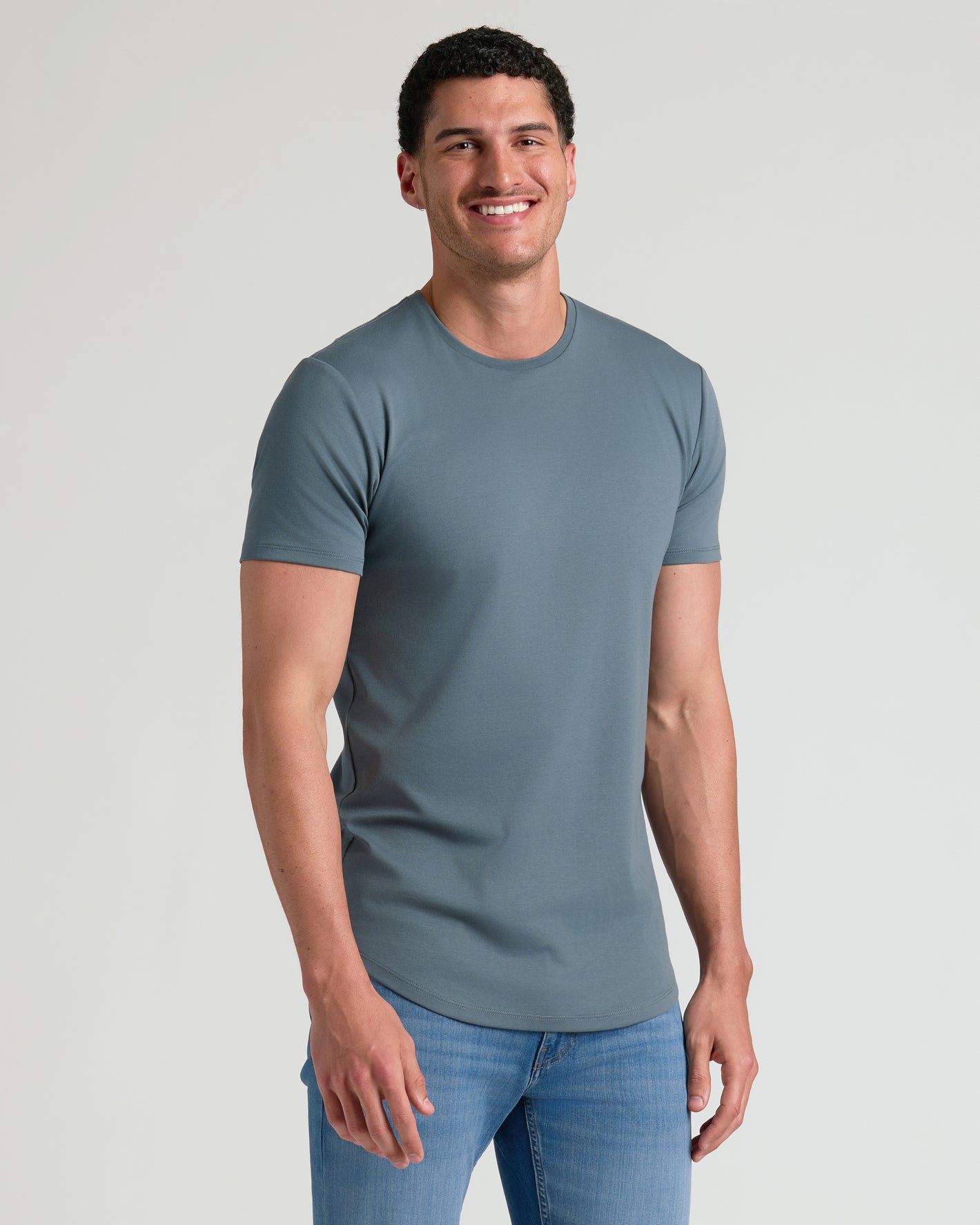 Timeless Tall Premium Pima Crew Curved Hem 4-Pack worn by a smiling man.