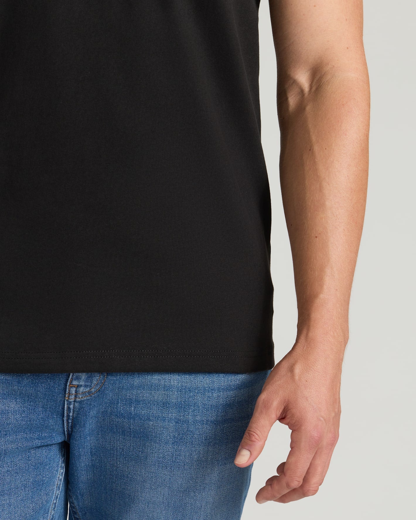 Black Tall Heavyweight Pocket Crew on model with blue jeans.